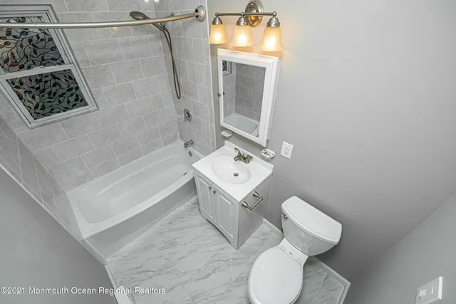 a bathroom with a toilet sink and shower