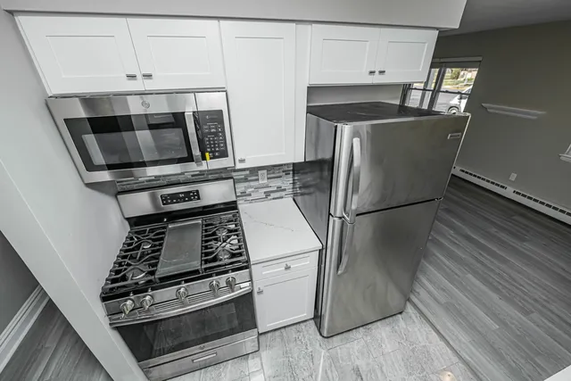 a kitchen with appliances and cabinets