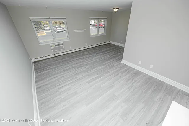 a view of wooden floor and windows in an empty room