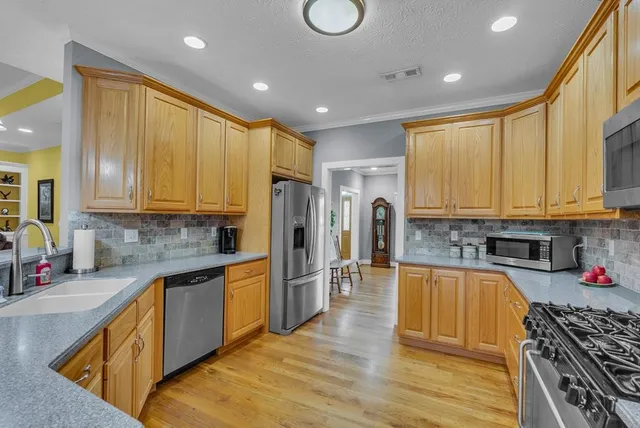 a view of a kitchen with kitchen island a large island in it