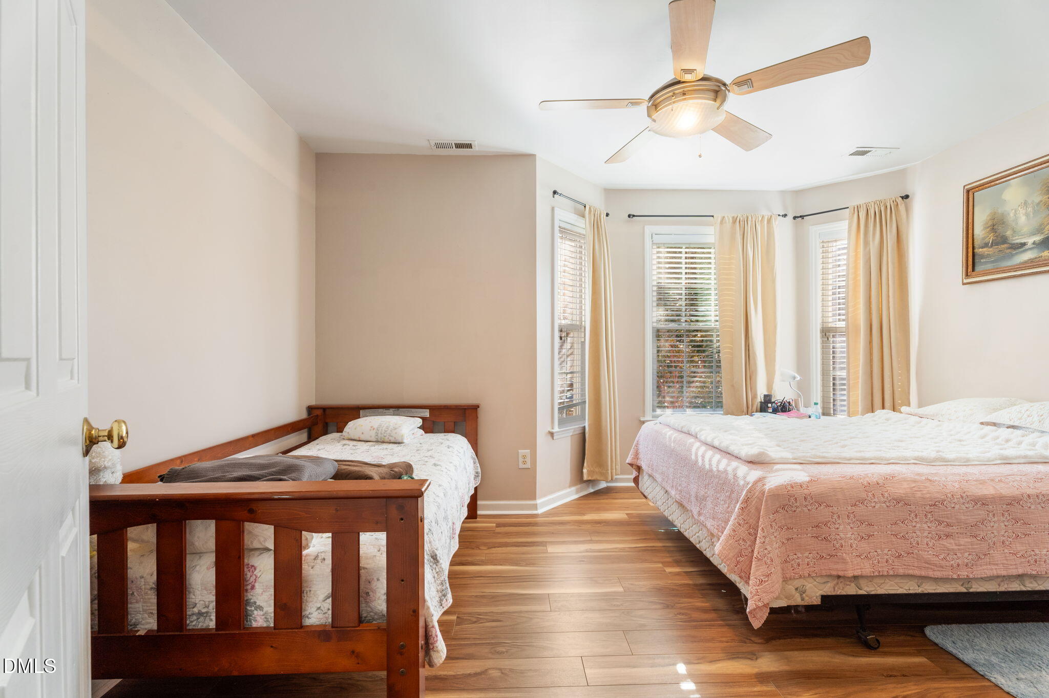 657 Flaherty Avenue Wake Forest, NC 27587 - Photo 11 of 25 a bedroom with a bed and wooden floor