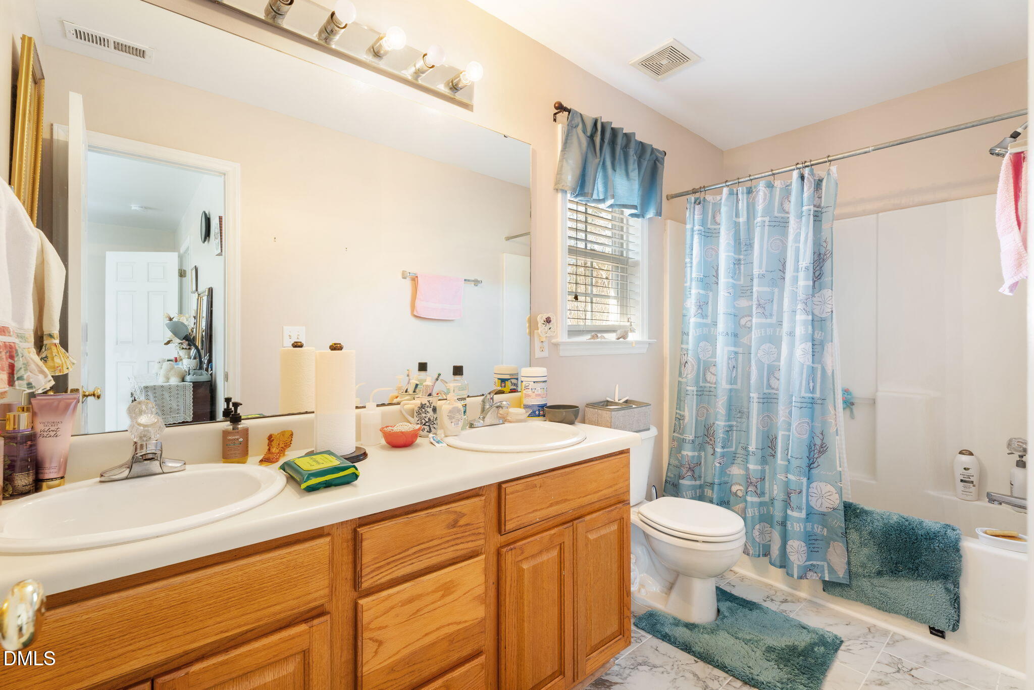 657 Flaherty Avenue Wake Forest, NC 27587 - Photo 14 of 25 a bathroom with a double vanity sink toilet and shower
