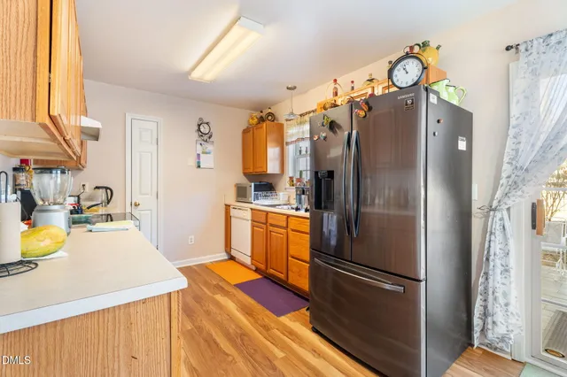 a kitchen with stainless steel appliances granite countertop a refrigerator and a stove