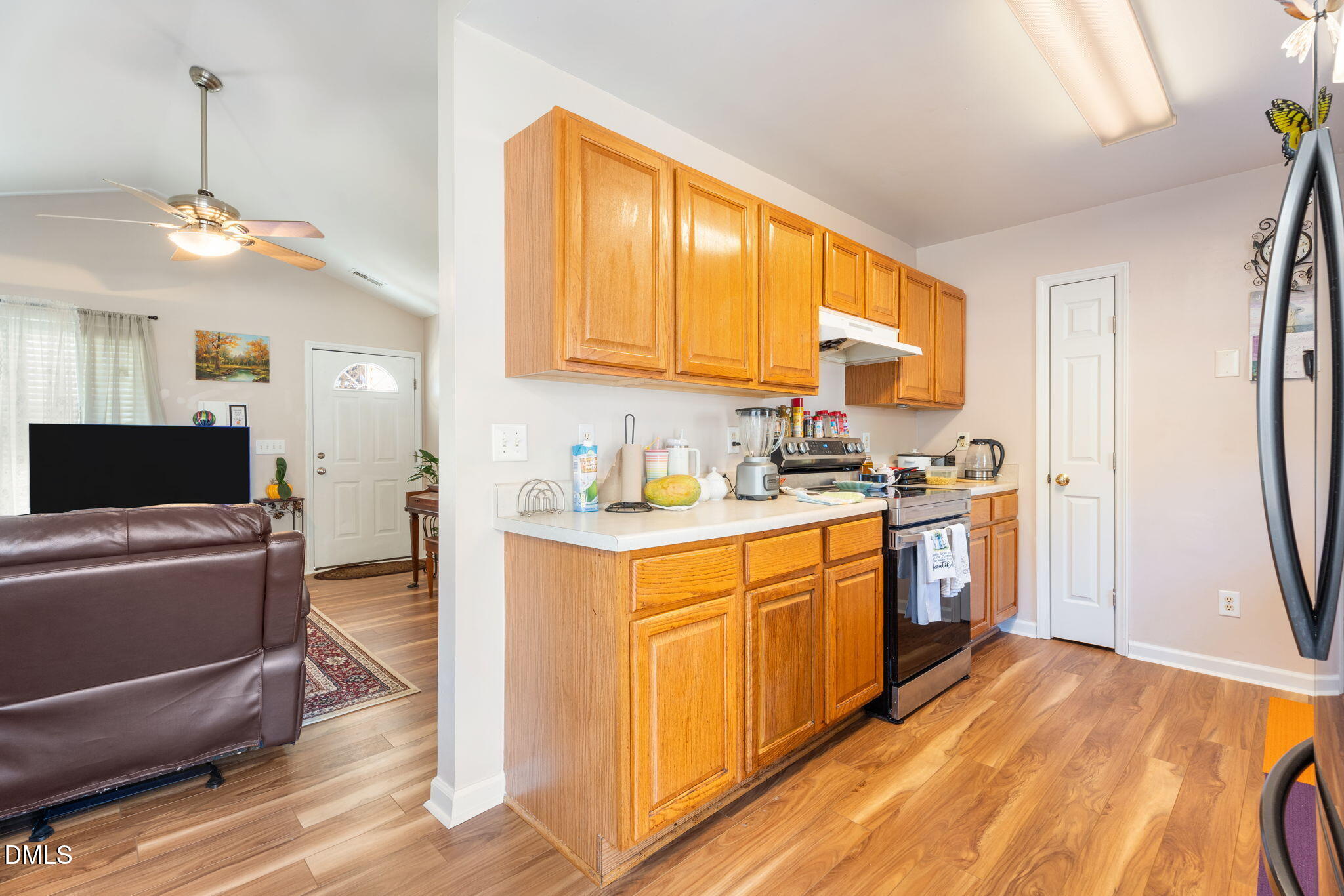 657 Flaherty Avenue Wake Forest, NC 27587 - Photo 6 of 25 a kitchen with stainless steel appliances granite countertop a refrigerator a sink dishwasher a stove with white cabinets and wooden floor