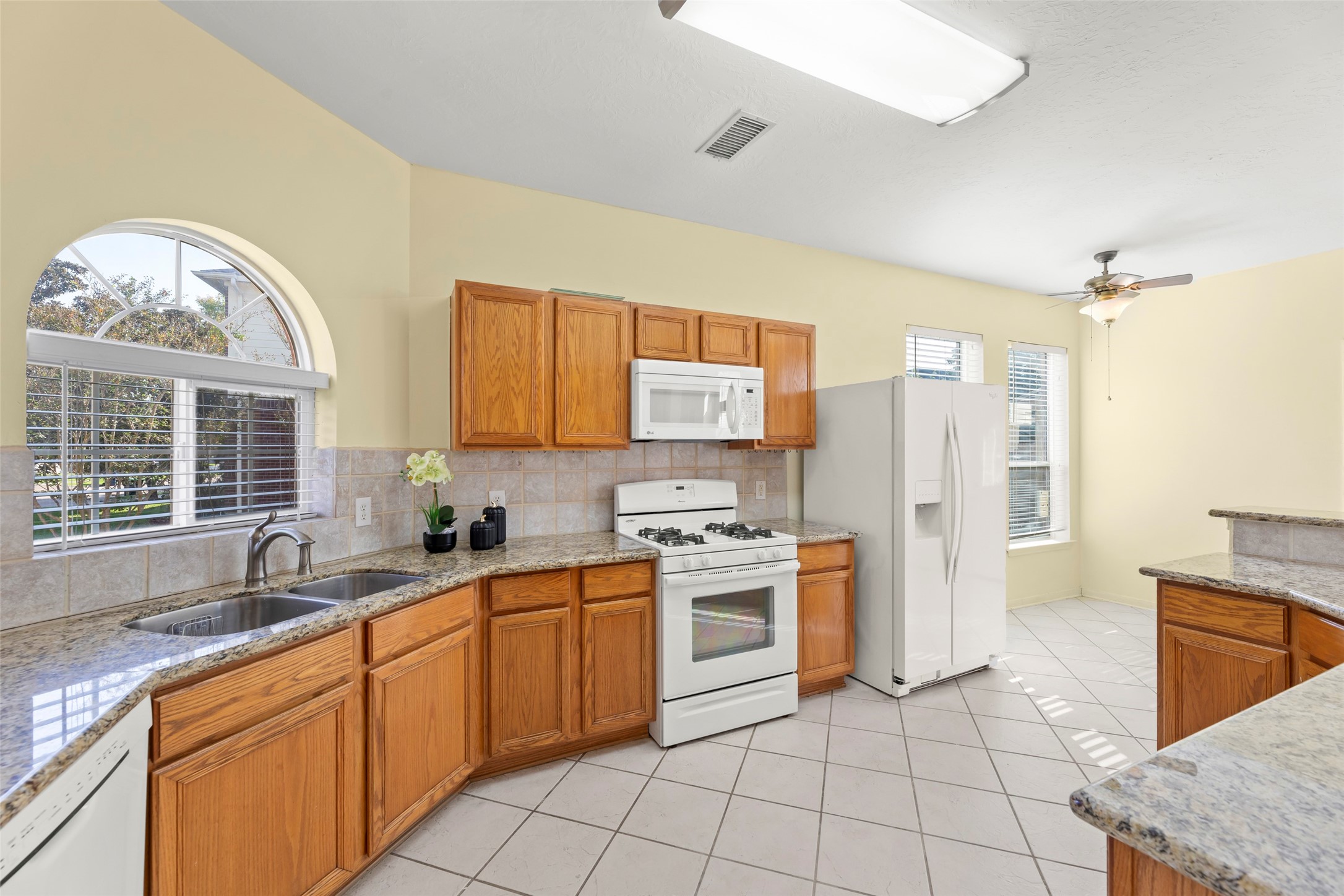 14715 Rancho Vista Drive Houston, TX 77083 - Photo 11 of 38 a kitchen with stainless steel appliances granite countertop a stove a sink and a refrigerator