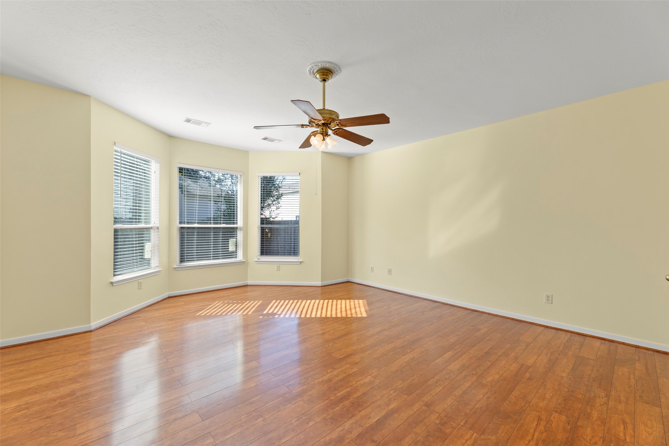 14715 Rancho Vista Drive Houston, TX 77083 - Photo 17 of 38 a view of an empty room with a window and wooden floor