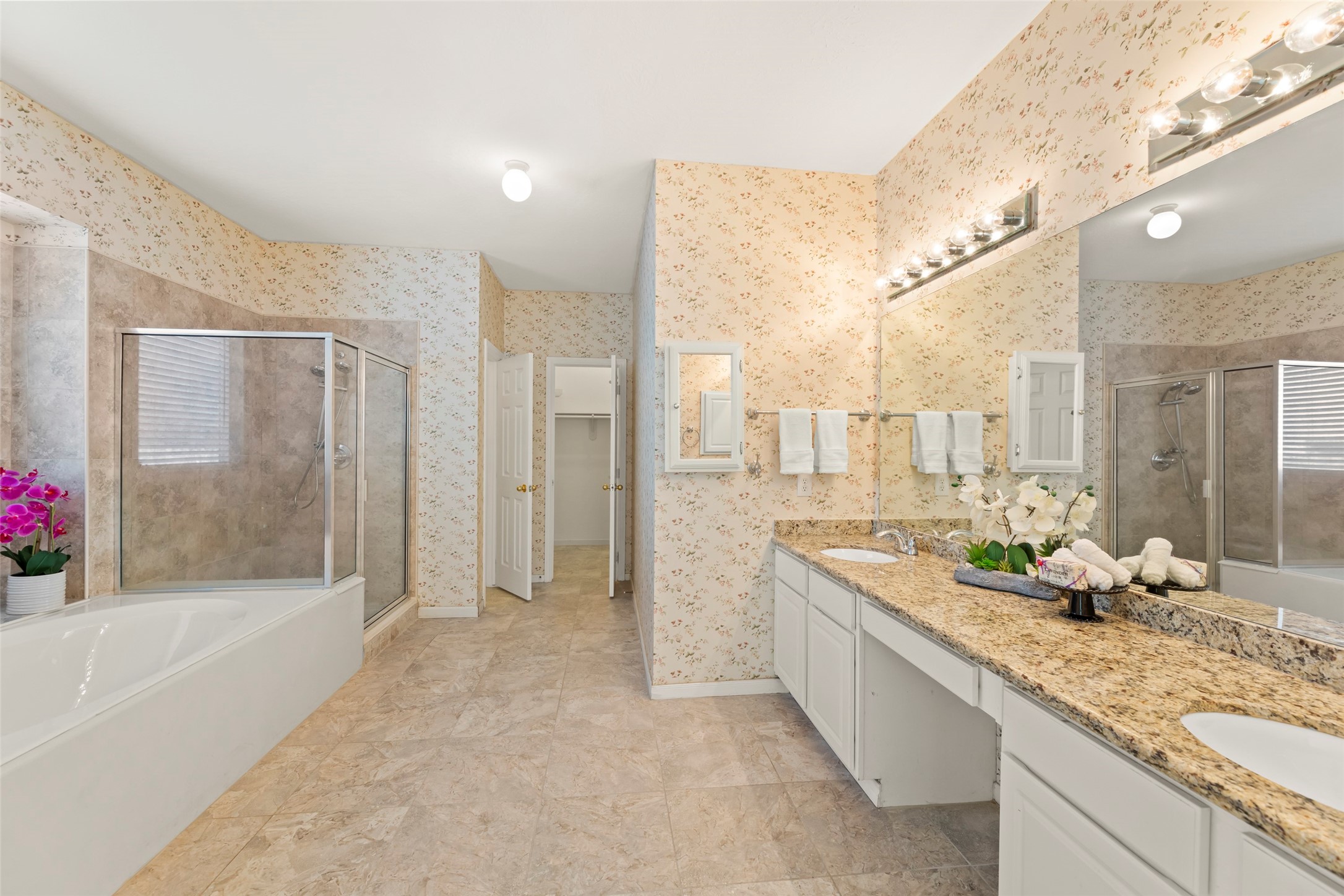 14715 Rancho Vista Drive Houston, TX 77083 - Photo 18 of 38 a spacious bathroom with a granite countertop tub sink a mirror and shower