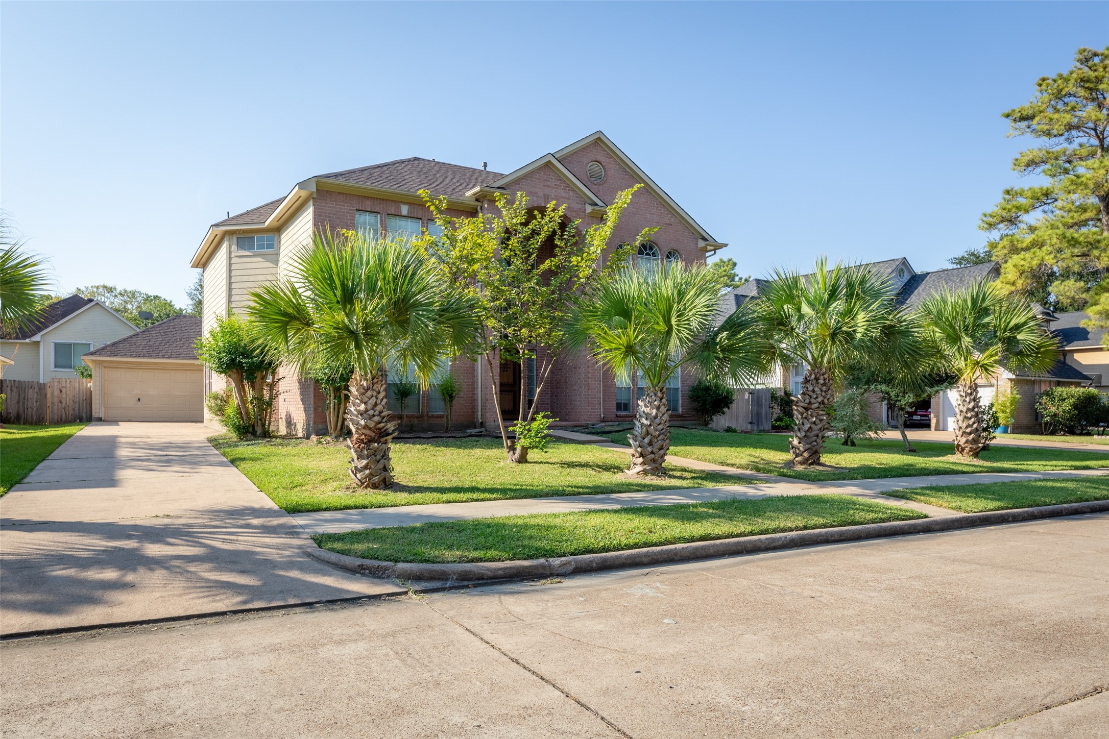 14715 Rancho Vista Drive Houston, TX 77083 - Photo 2 of 38 a front view of a house with a yard and trees