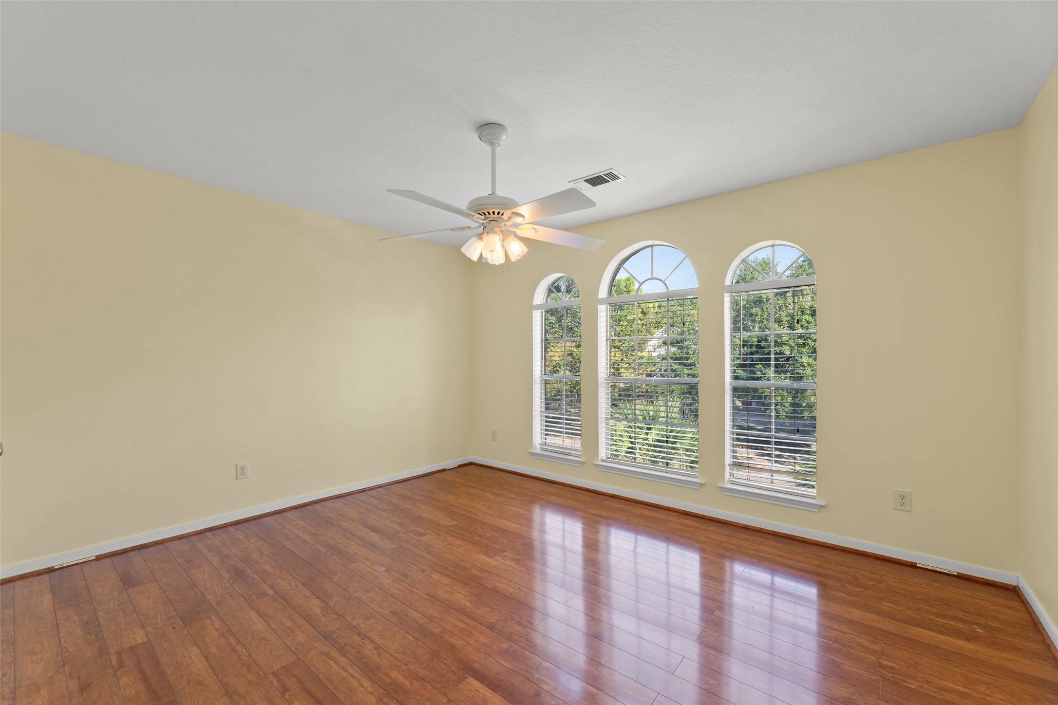 14715 Rancho Vista Drive Houston, TX 77083 - Photo 26 of 38 a view of an empty room with wooden floor fan and a window