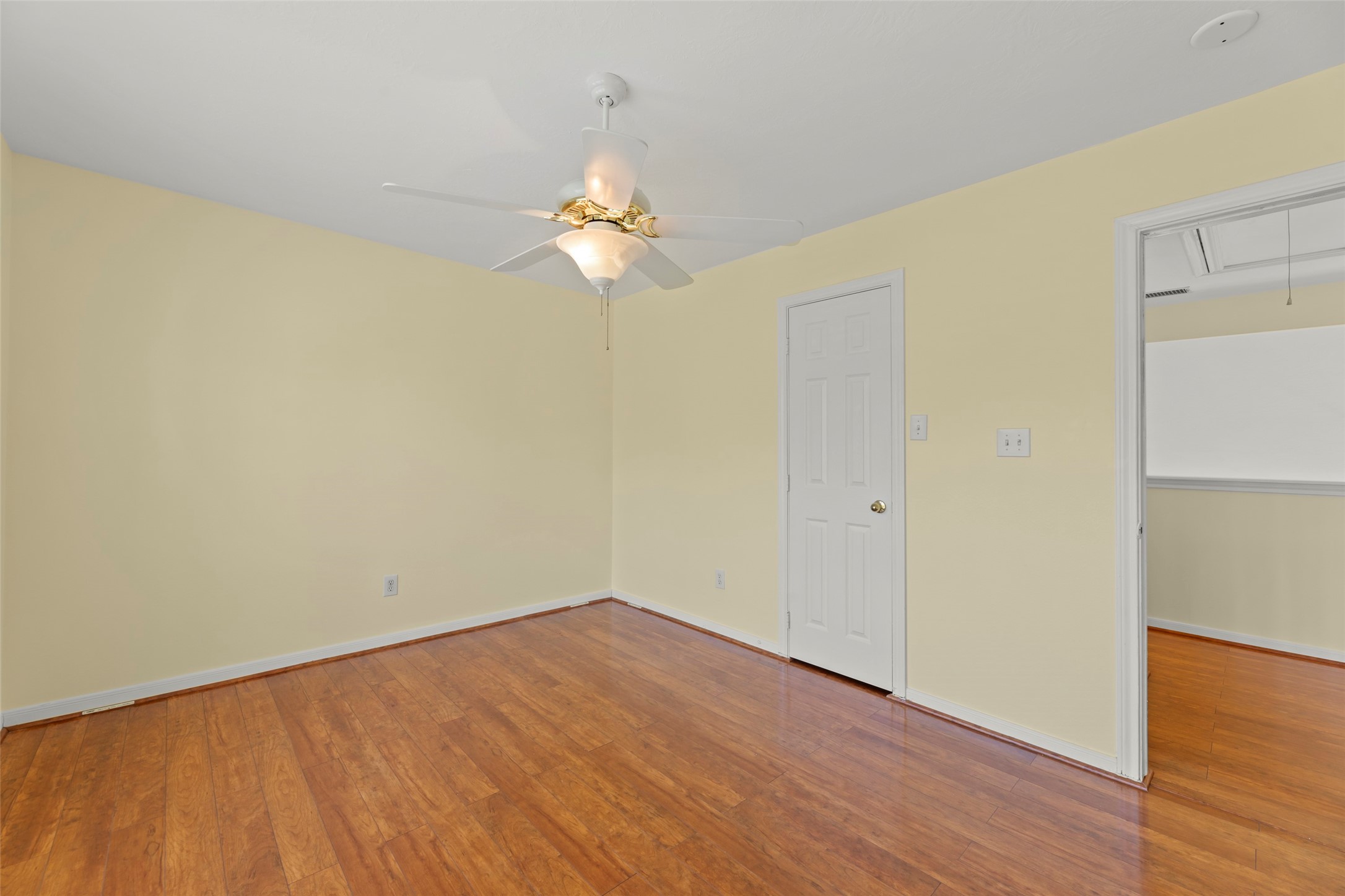 14715 Rancho Vista Drive Houston, TX 77083 - Photo 29 of 38 an empty room with wooden floor and fan