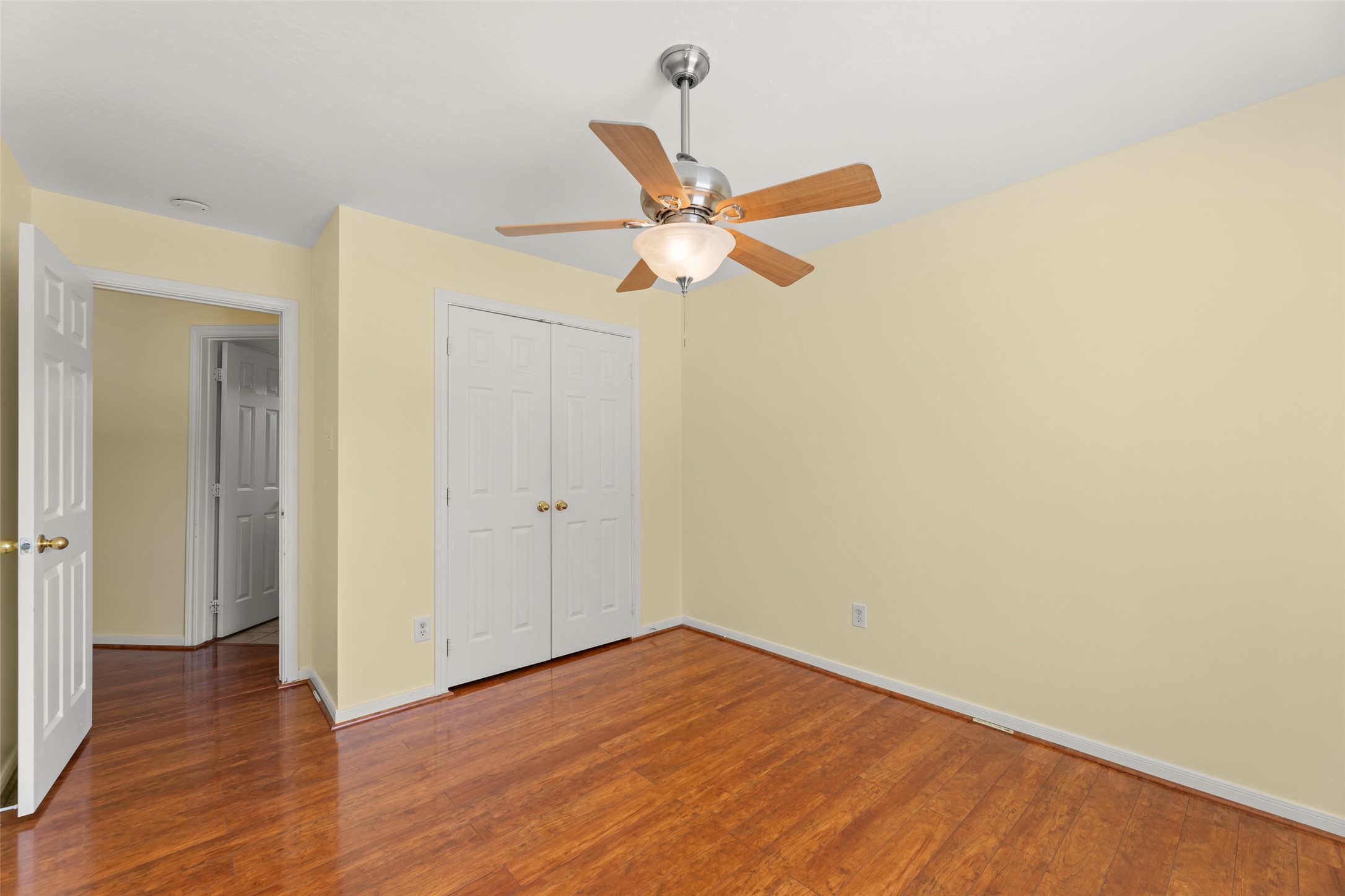 14715 Rancho Vista Drive Houston, TX 77083 - Photo 33 of 38 a view of a room with wooden floor and a ceiling fan