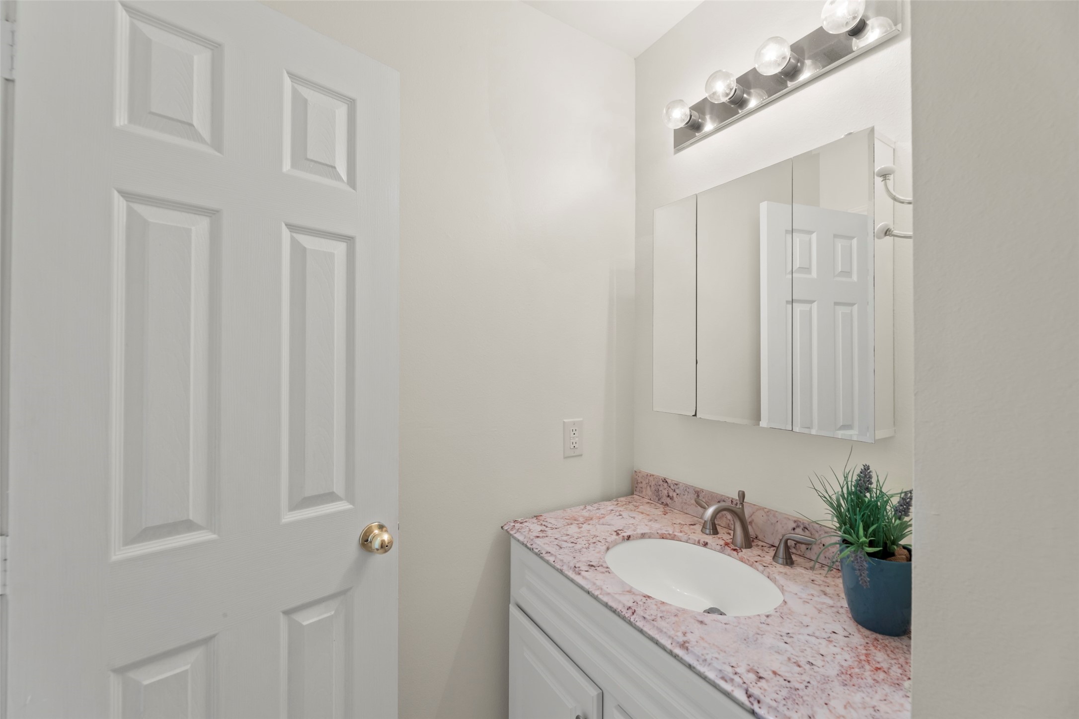 14715 Rancho Vista Drive Houston, TX 77083 - Photo 34 of 38 a bathroom with a granite countertop sink and mirror