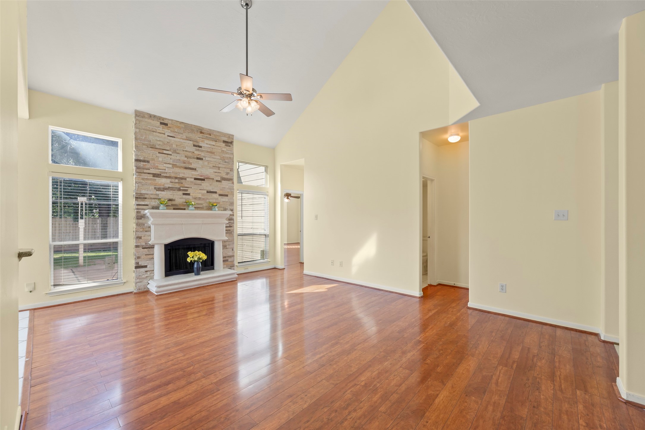 14715 Rancho Vista Drive Houston, TX 77083 - Photo 7 of 38 a view of a livingroom with wooden floor a fireplace and window
