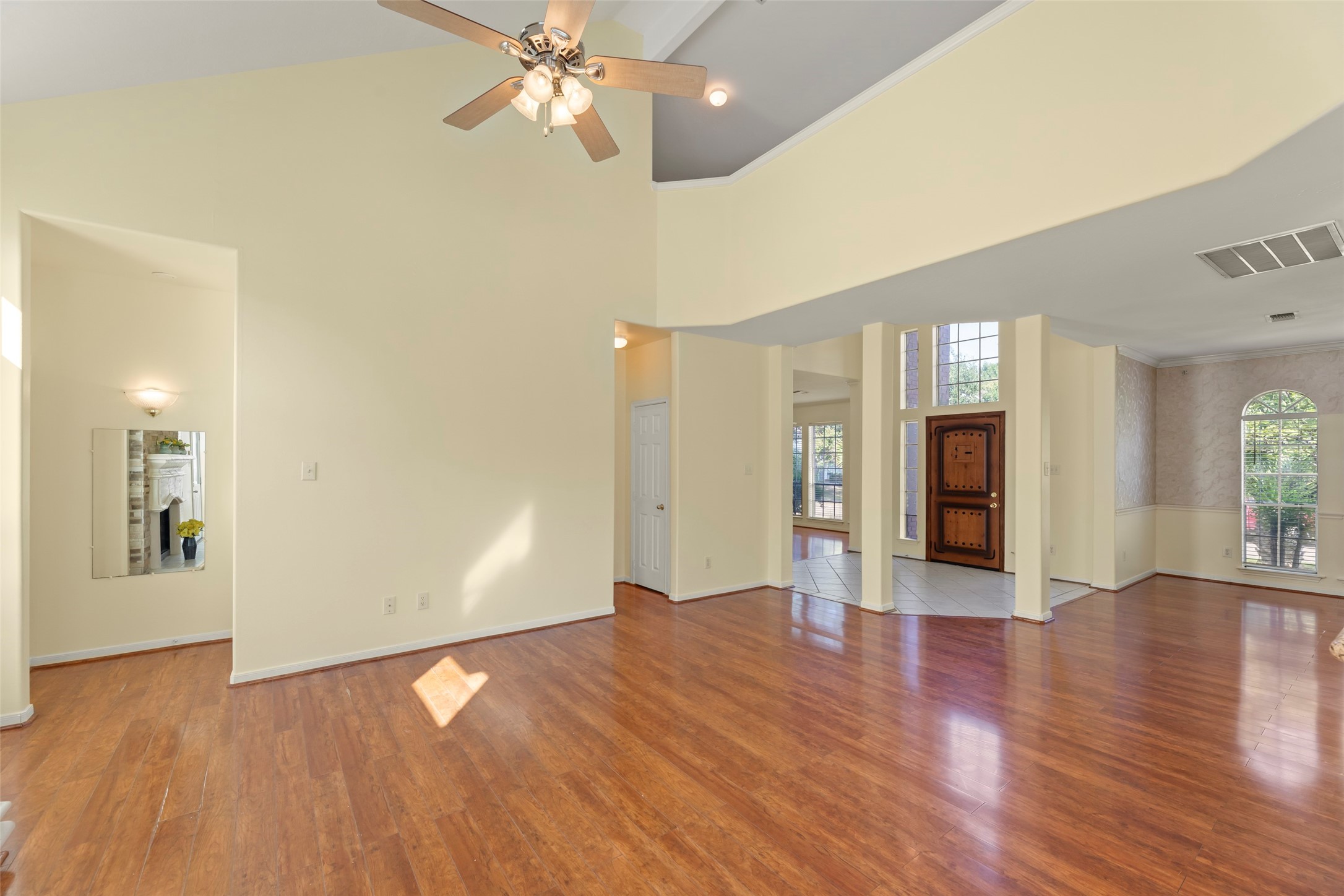 14715 Rancho Vista Drive Houston, TX 77083 - Photo 8 of 38 a view of an empty room with wooden floor and a ceiling fan