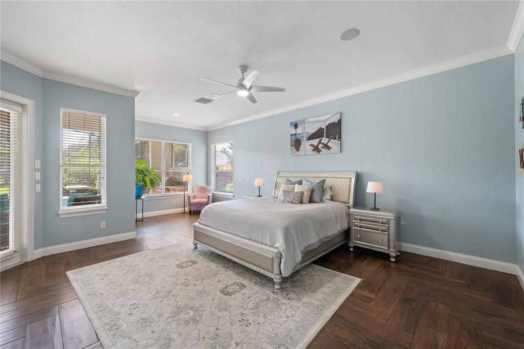 2002 Water Key Drive Windermere, FL 34786 - Photo 17 of 60 a spacious bedroom with a bed and wooden floor