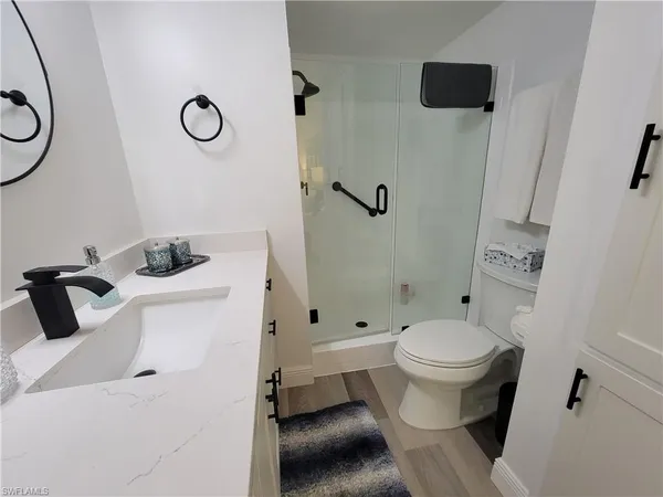 a bathroom with a sink toilet and shower