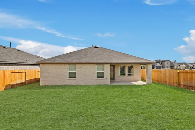 a view of a house with a yard and a porch