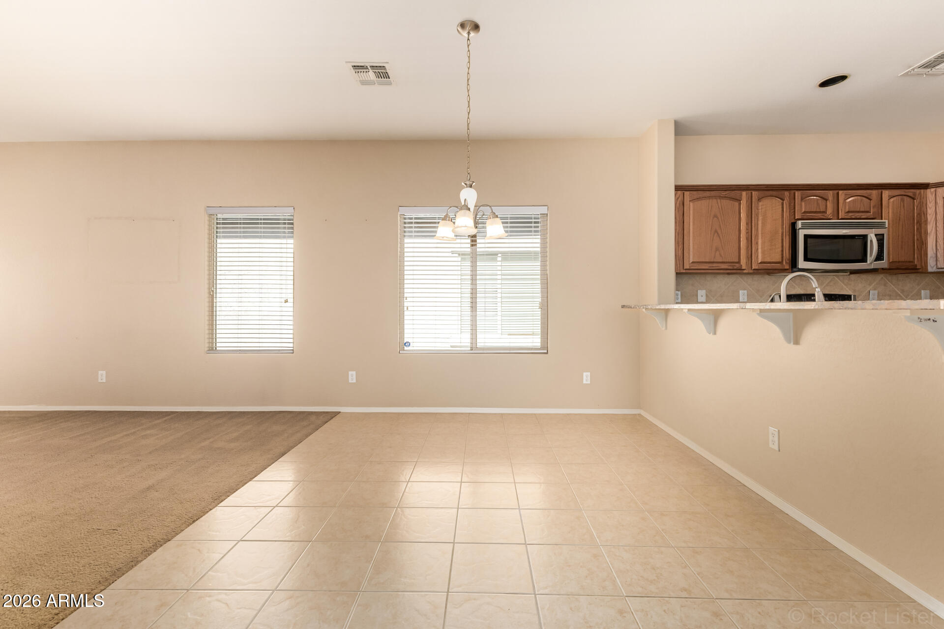 28314 North Crimm Road San Tan Valley, AZ 85143 - Photo 11 of 31 a view of a kitchen with an empty space and a window