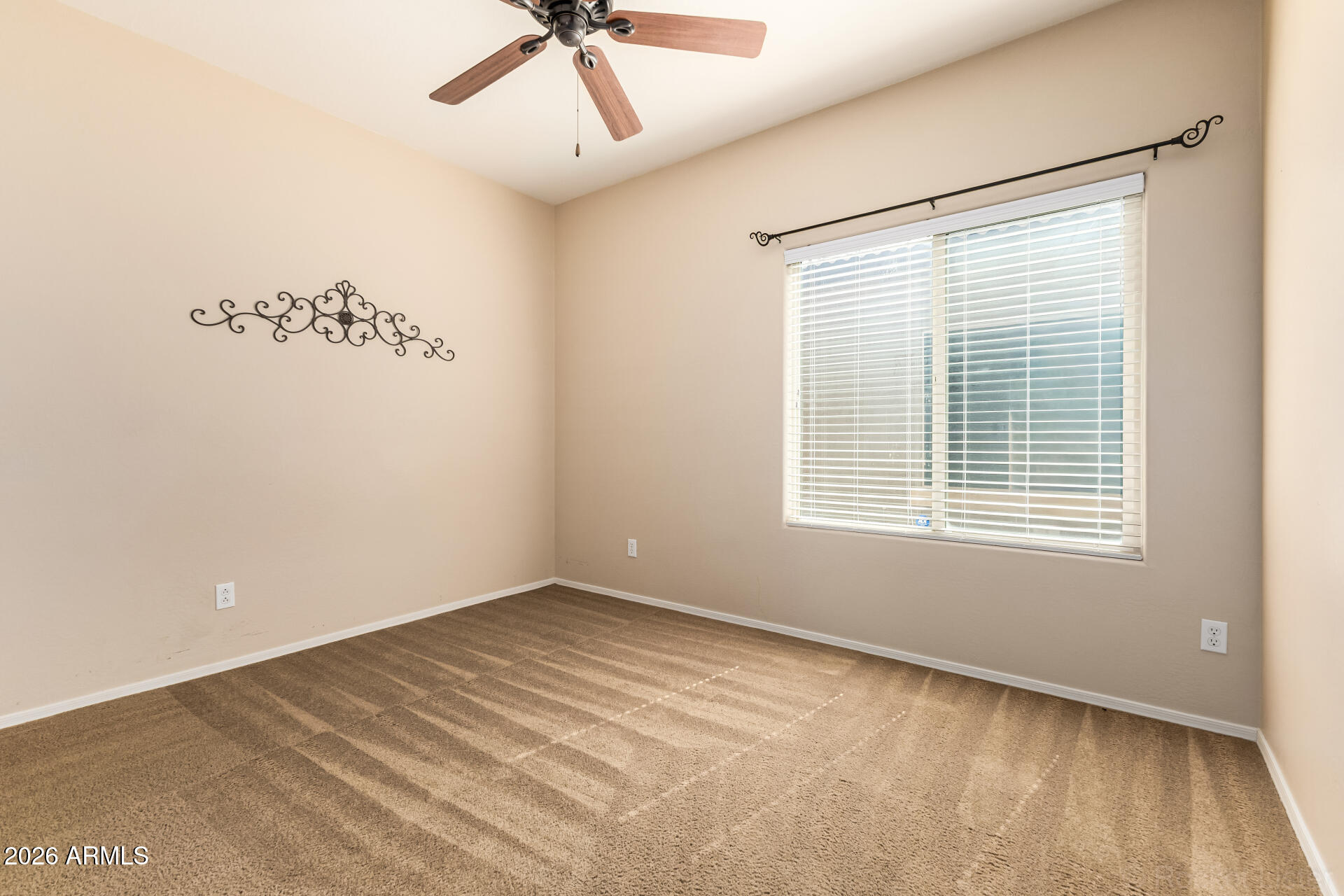 28314 North Crimm Road San Tan Valley, AZ 85143 - Photo 19 of 31 a view of an empty room with a window and a ceiling fan