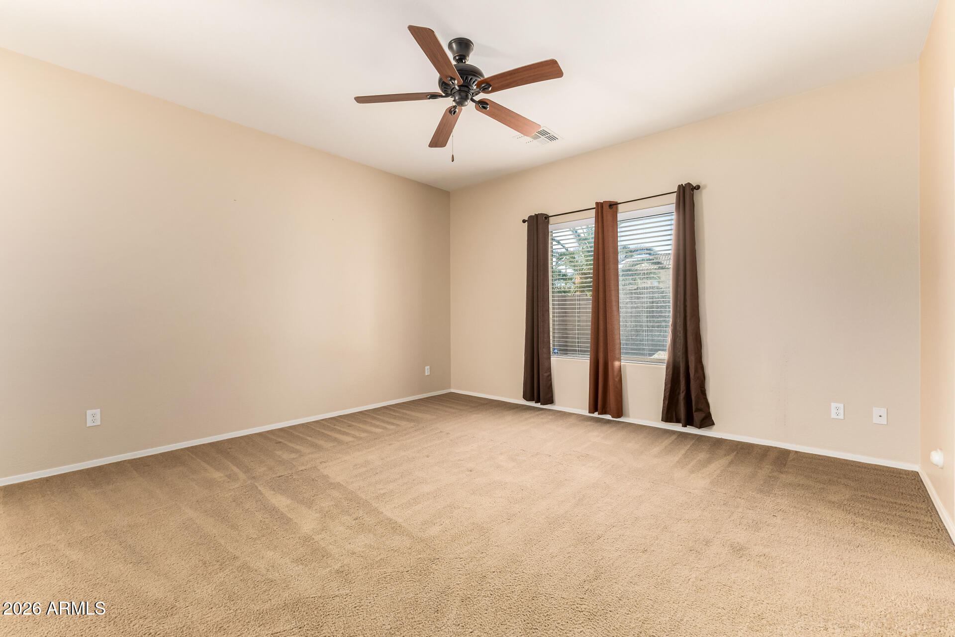 28314 North Crimm Road San Tan Valley, AZ 85143 - Photo 25 of 31 an empty room with chandelier fan and windows