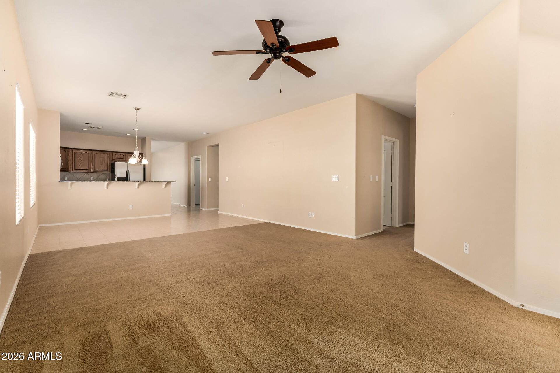28314 North Crimm Road San Tan Valley, AZ 85143 - Photo 8 of 31 a view of an empty room with a ceiling fan
