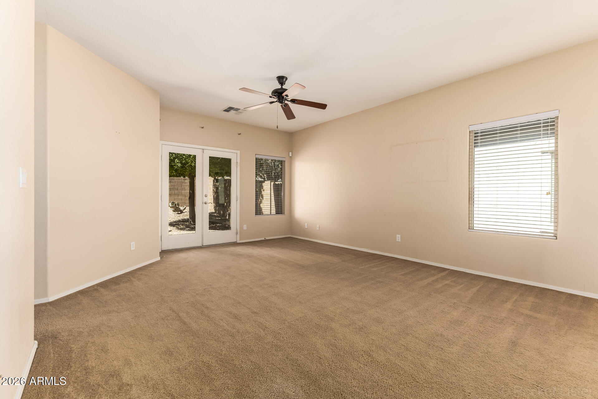 28314 North Crimm Road San Tan Valley, AZ 85143 - Photo 9 of 31 an empty room with windows and fan