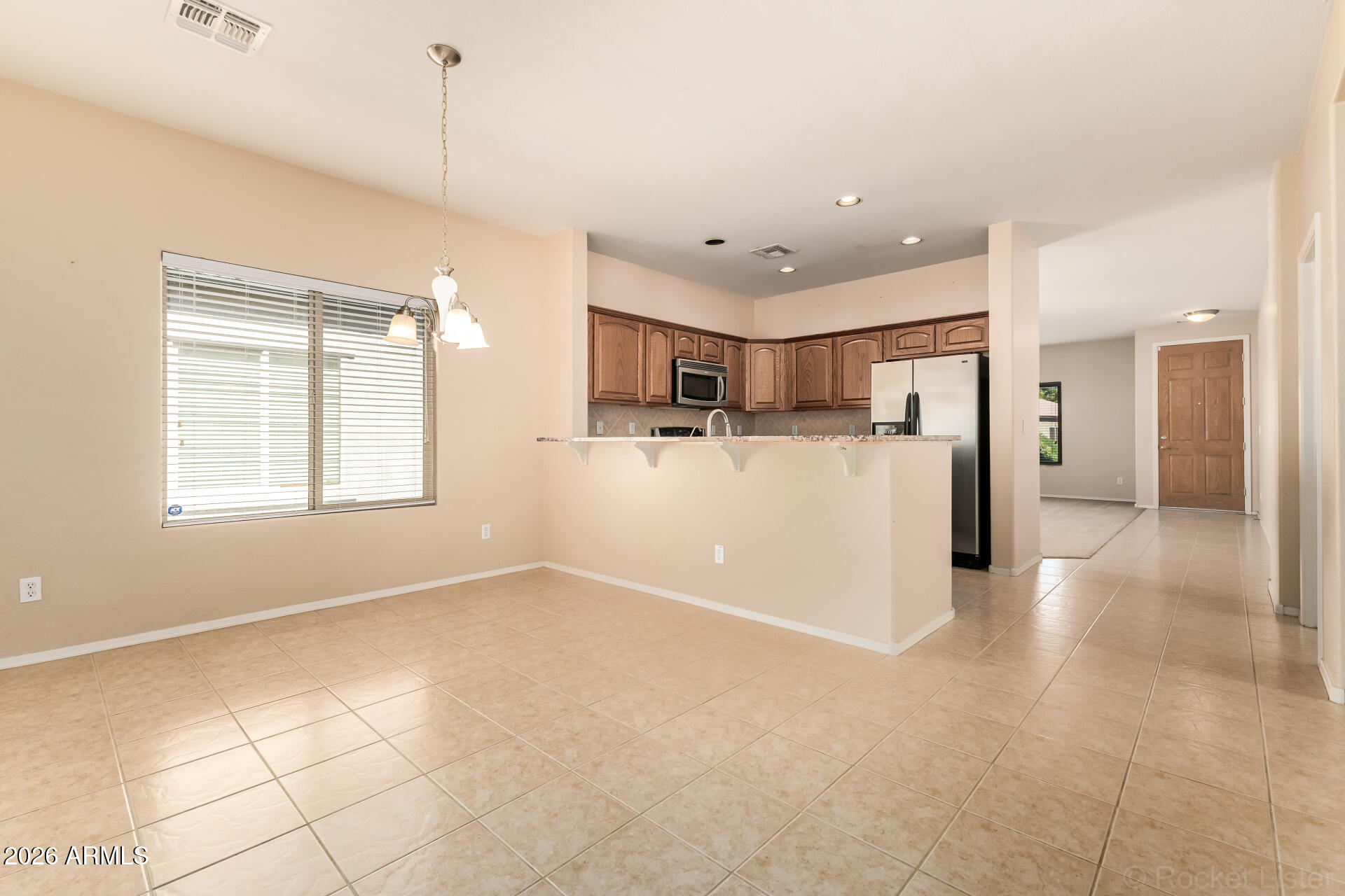 28314 North Crimm Road San Tan Valley, AZ 85143 - Photo 10 of 31 a view of a kitchen with a refrigerator and a window