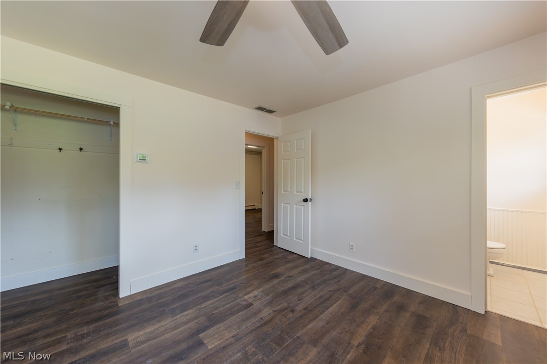 7969 Dines Road Novelty, OH 44072 - Photo 21 of 48 Primary bedroom featuring wood-finish flooring, large closet, white baseboards, and a ceiling fan