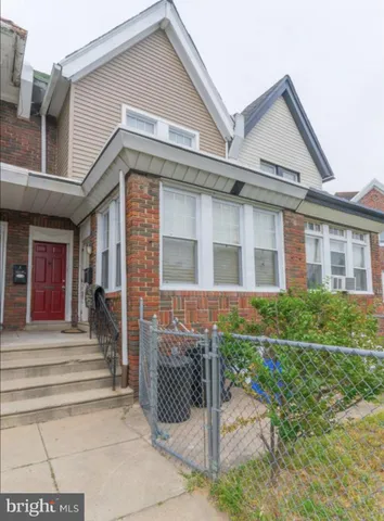 a front view of a house with a garden and plants