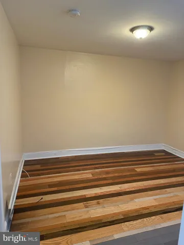 a view of room with stairs and wooden floor