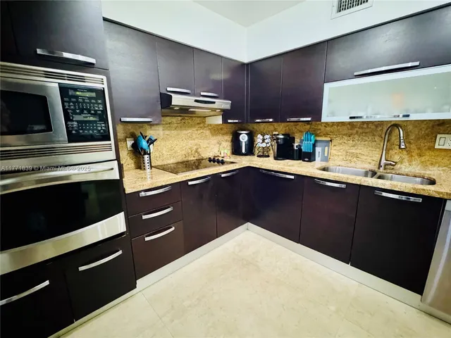 a kitchen with stainless steel appliances a sink and a stove