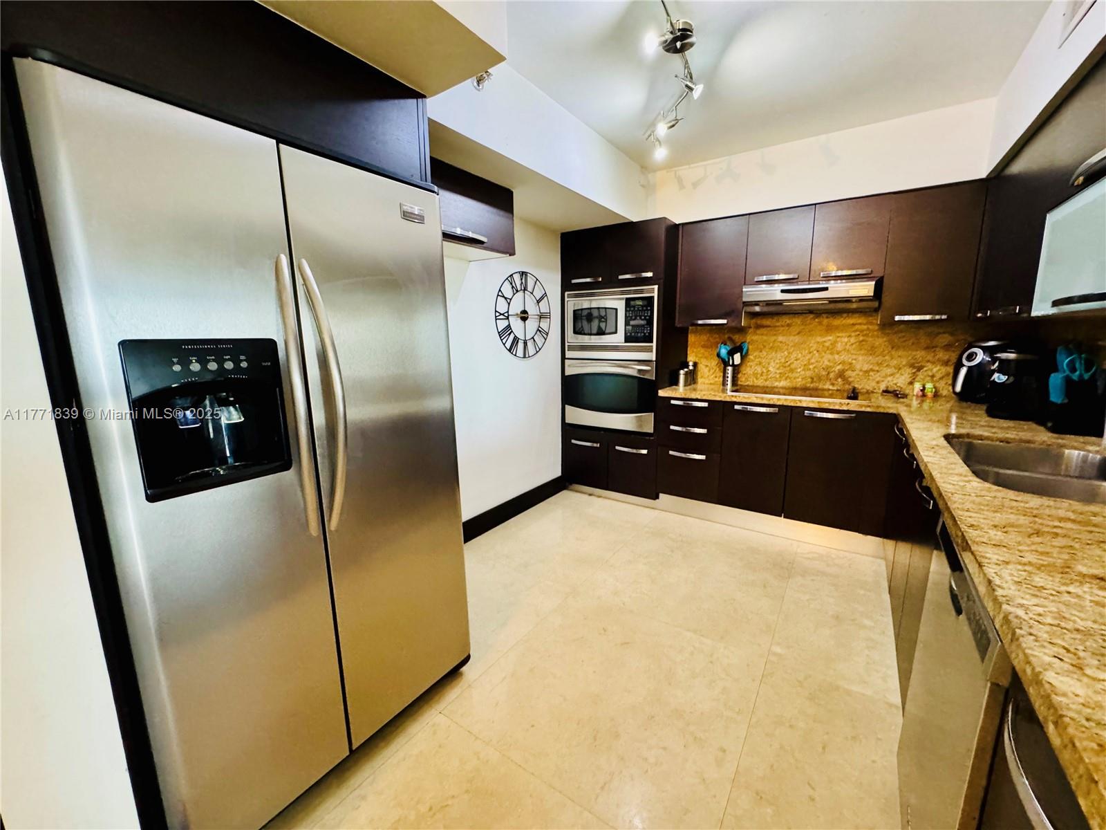 3600 Mystic Pointe Drive, Unit 1210 Aventura, FL 33180 - Photo 5 of 68 a kitchen with stainless steel appliances a refrigerator a sink a stove and cabinets