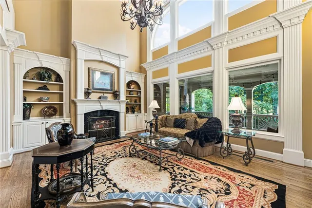 a living room with furniture fireplace and a large window