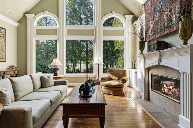 a kitchen with large windows sink and stove