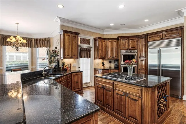 a bedroom with a bed and large windows