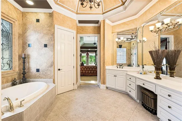 a spacious bedroom with a large bed and a flat tv screen on dresser