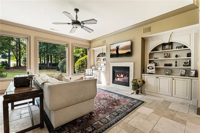 a bedroom with furniture and large windows