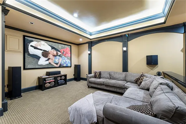 a front view of a house with a garden and trees