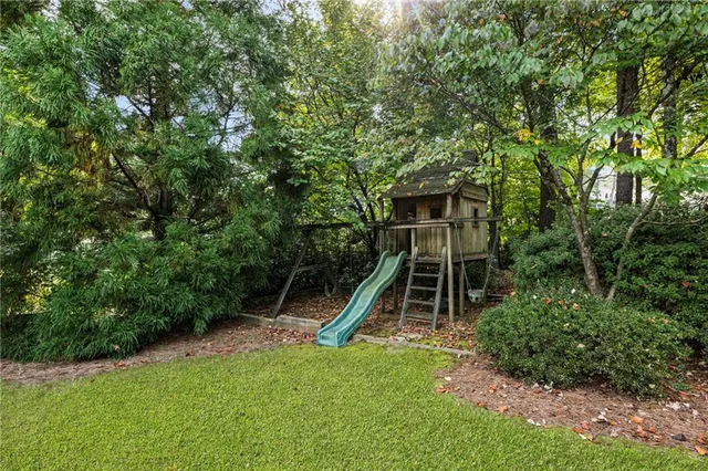 a view of a patio with table and chairs potted plants with wooden floor and fence