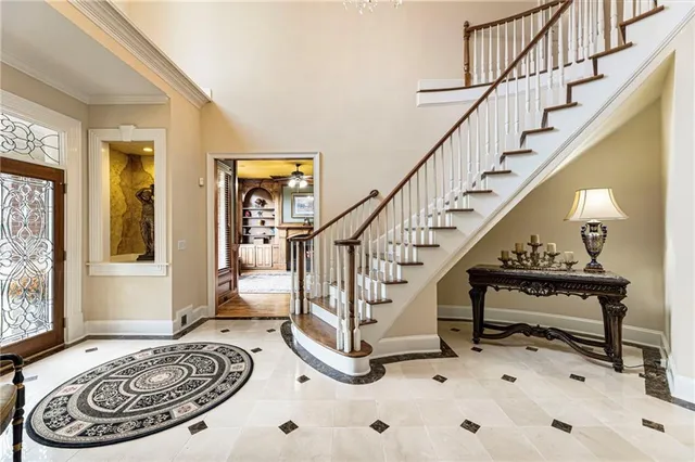 a view of a dining room with furniture a chandelier and wooden floor