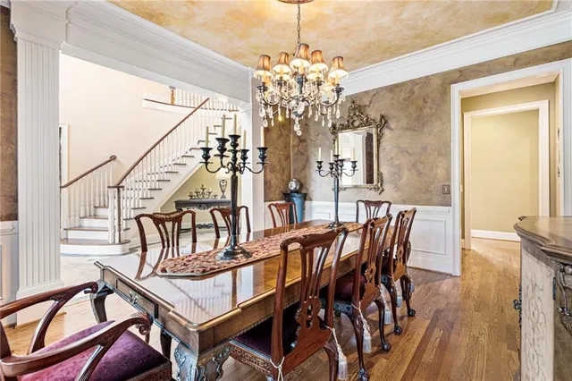a living room with furniture a fireplace and a floor to ceiling window