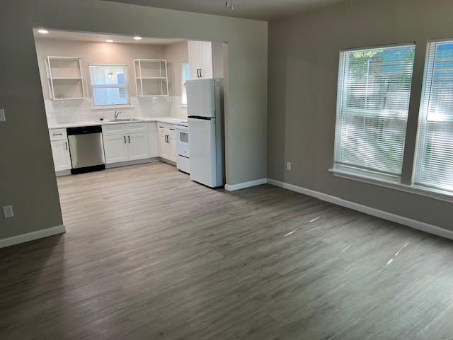 1513 Panhandle Street, Unit A Denton, TX 76201 - Photo 2 of 6 an empty room with wooden floor and a window