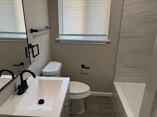 1513 Panhandle Street, Unit A Denton, TX 76201 - Photo 6 of 6 a bathroom with a sink a toilet and a bathtub