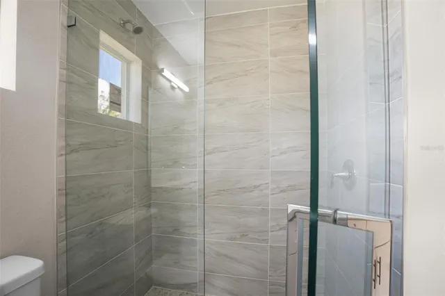 a bathroom with a toilet and shower