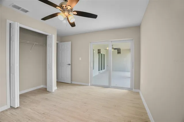 a view of empty room with wooden floor
