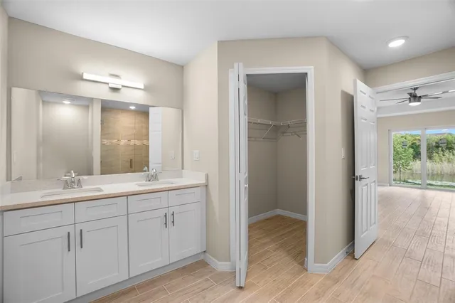 a bathroom with a double vanity sink and a mirror