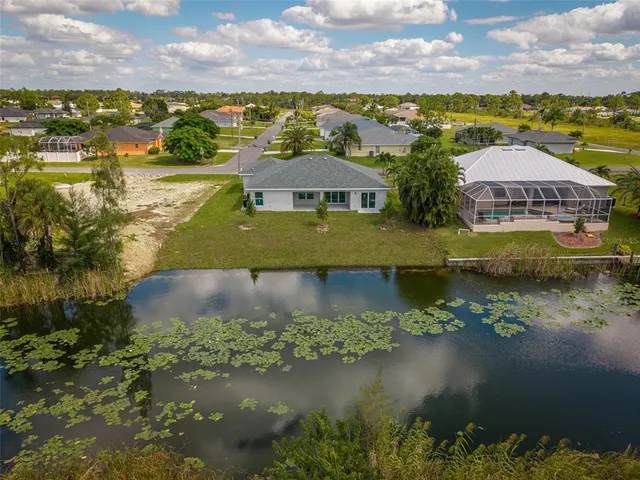 an aerial view of residential houses with lake view