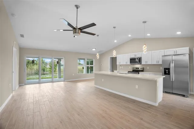 a kitchen with stainless steel appliances a refrigerator sink and stove