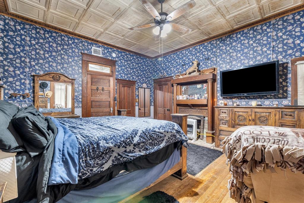 421 Huey Avenue Mount Calm, TX 76673 - Photo 14 of 39 a bedroom with a bed a flat screen tv and dresser