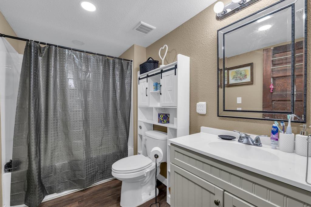 421 Huey Avenue Mount Calm, TX 76673 - Photo 18 of 39 a bathroom with a sink a toilet and shower